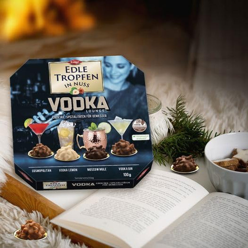 Edle Tropfen in Nuss Vodka Lounge 100g, praline di cioccolato ripiene di liquido con glassa di cioccolato al latte e pezzetti croccanti di nocciola
