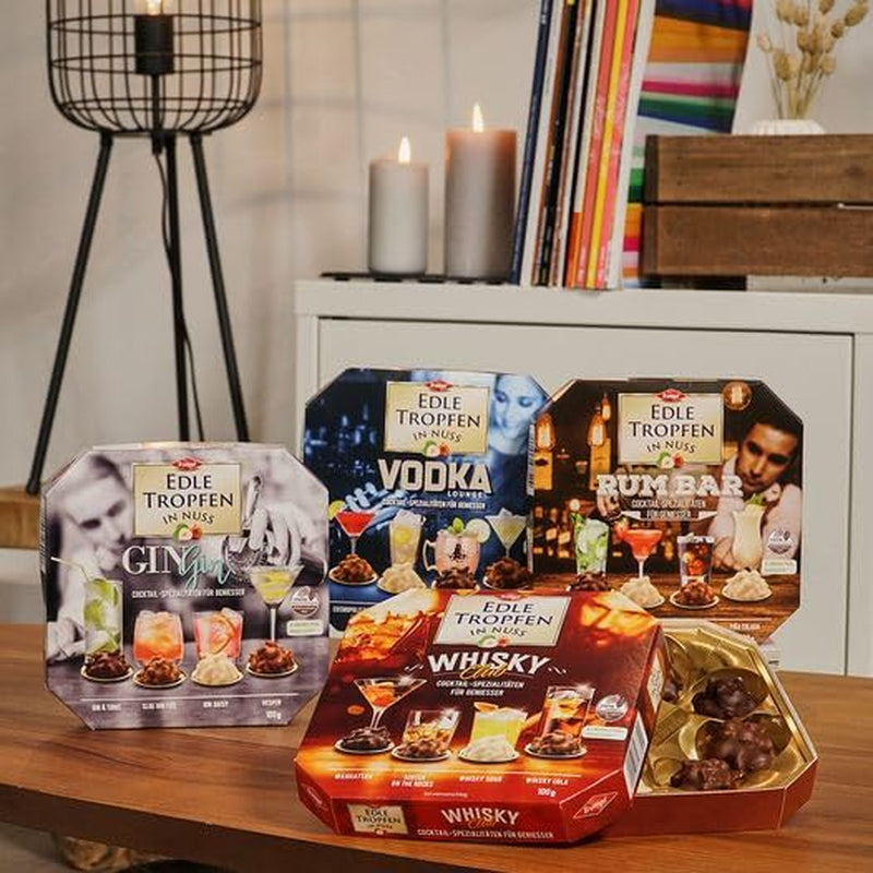 Edle Tropfen in Nuss Vodka Lounge 100g, praline di cioccolato ripiene di liquido con glassa di cioccolato al latte e pezzetti croccanti di nocciola