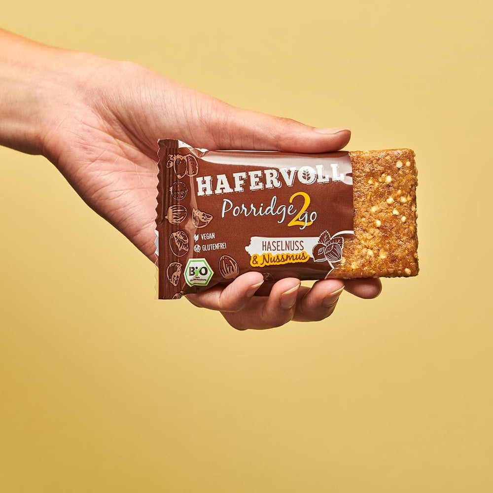 Hafervoll Porridge2go Unt de alune și nuci, 13 batoane x 55g - Vegan, Organic, Fără gluten, Gustare fără zahăr adăugat, cu ovăz, curmale și bomboane de quinoa
